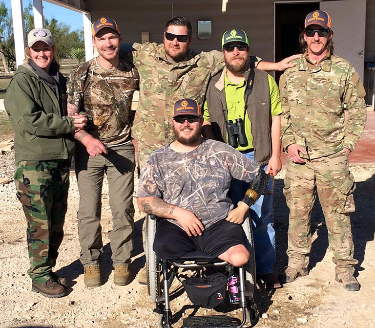 smiling small group of veterans in camo